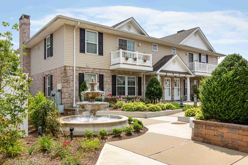 a fountain sits in front of a house