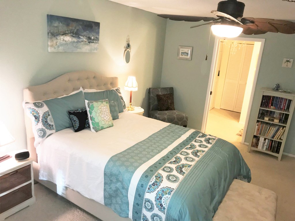 the master bedroom has a king sized bed and a closet