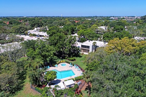 a aerial view of the resort with a pool and trees