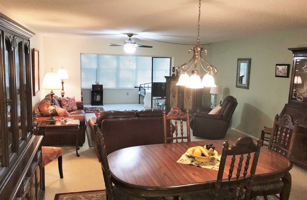 a dining room and living room with a table and chairs