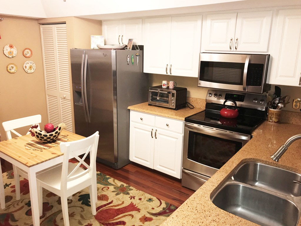 a kitchen with stainless steel appliances and a table