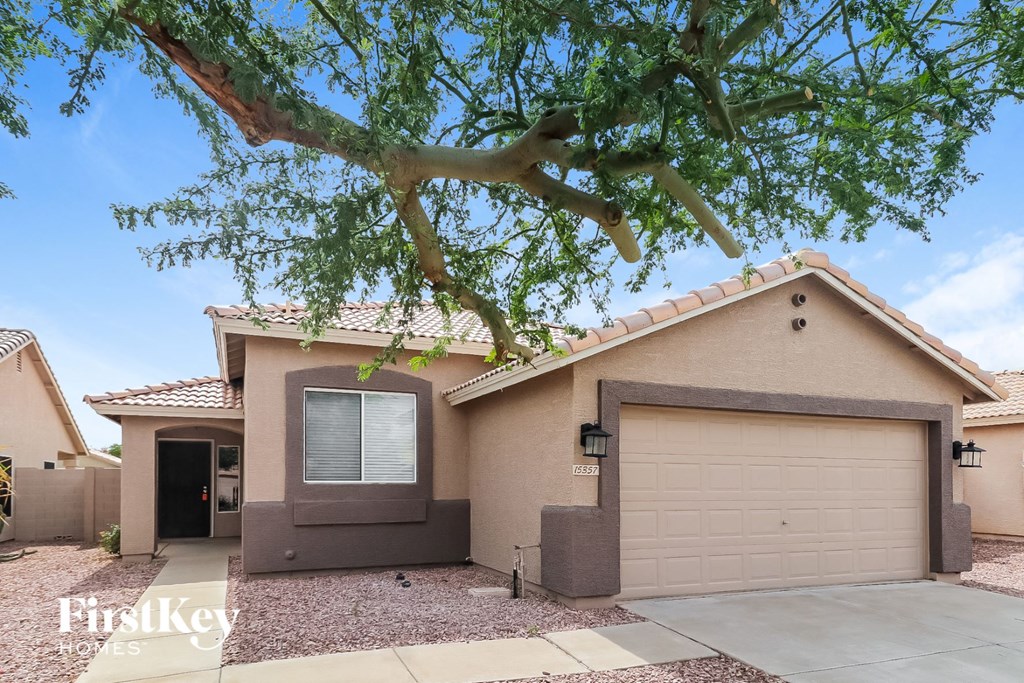 A house with a tree in front of it.
