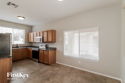 A kitchen with wooden cabinets and a black countertop.