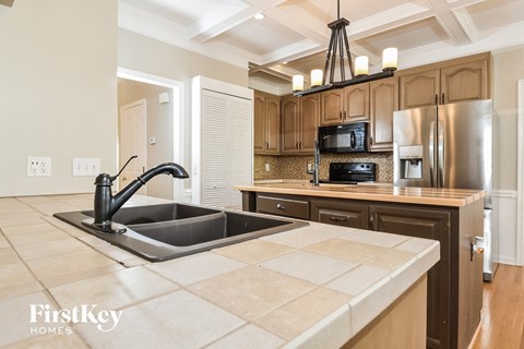 a kitchen with stainless steel appliances and a large sink