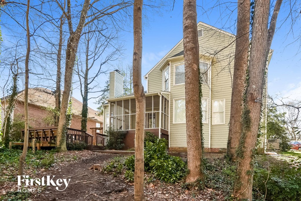 a view of a house with trees in front of it