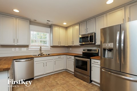 a kitchen with stainless steel appliances and white cabinets