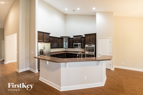 a kitchen with an island with granite counter top and