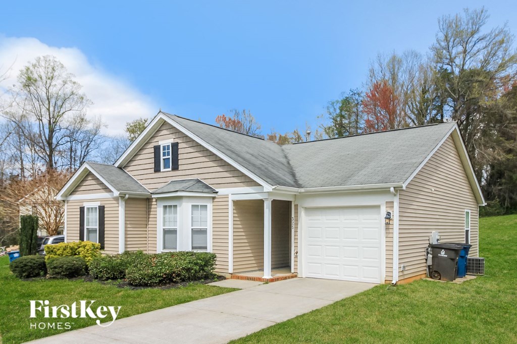 a small tan and with a driveway