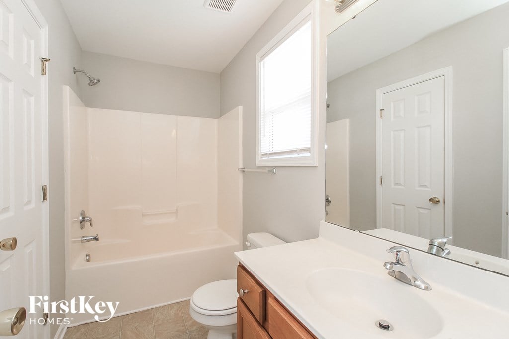 a bathroom with a sink and a toilet and a tub