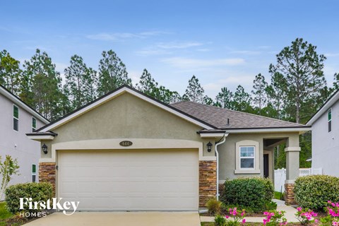 a home with a white garage door in front of it