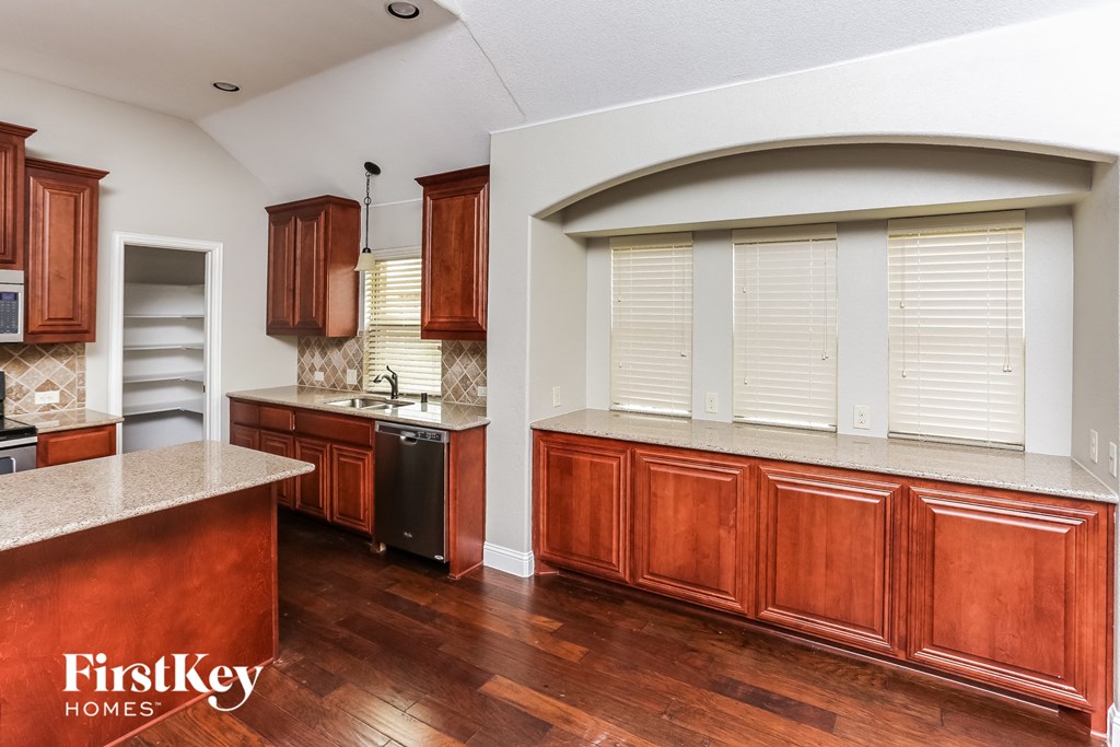 A kitchen with wooden cabinets and a countertop.