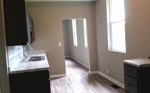 A kitchen with a sink and a window.