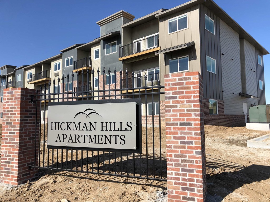 a sign apartments in front of an apartment building
