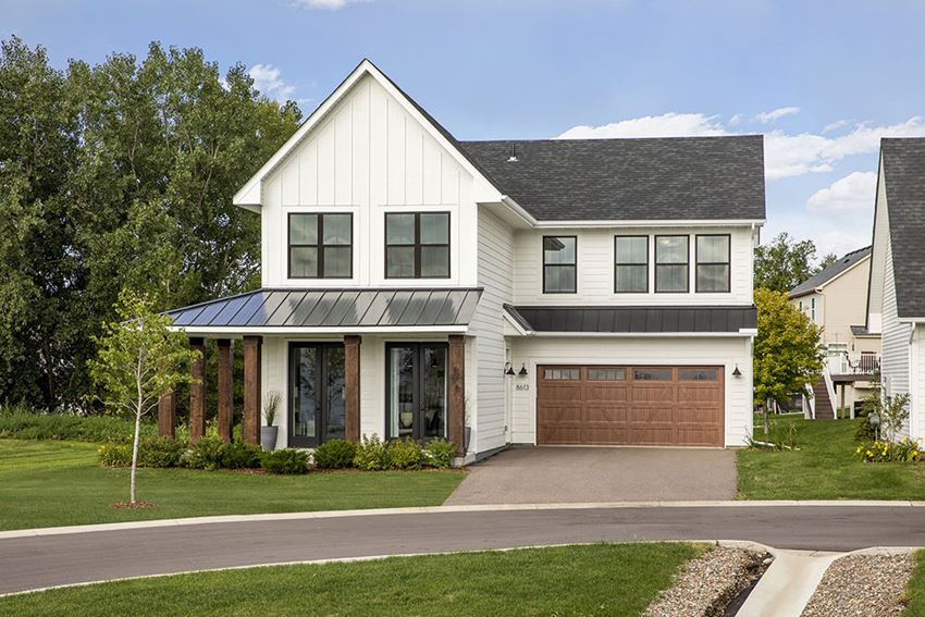 a white house with a brown garage door