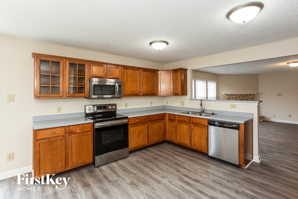 a kitchen with wooden cabinets and stainless steel appliances