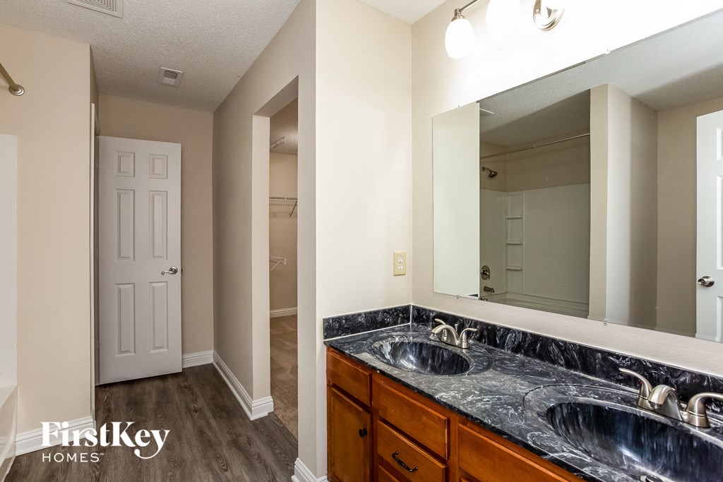 a bathroom with two sinks and a large mirror