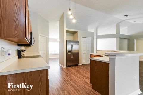 A kitchen with wooden cabinets and a white countertop.