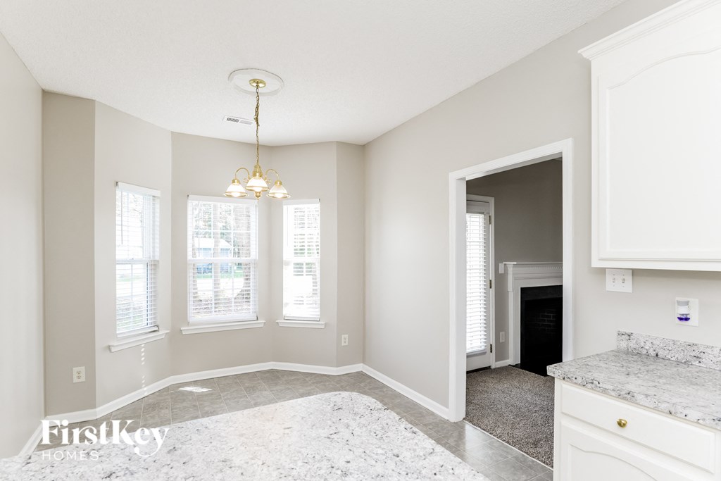 a kitchen and dining room with a fireplace and a chandelier