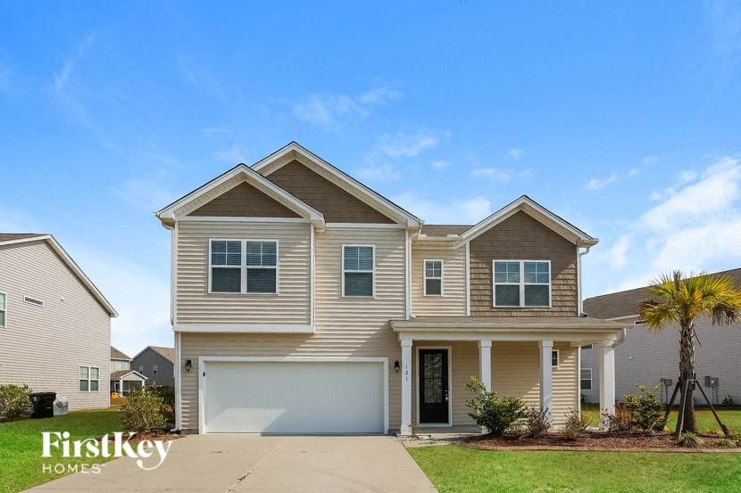 a beige house with a white garage door