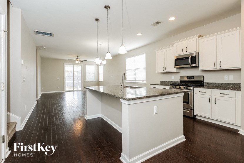 a kitchen with white cabinets and a counter top