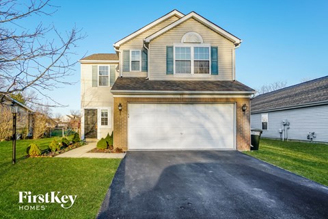 a house with a white garage door on a driveway