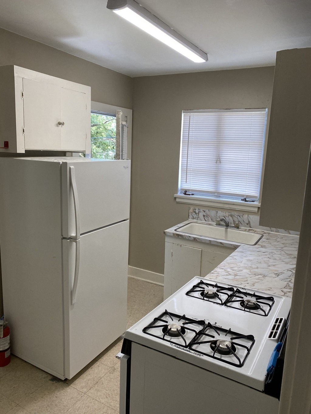 a kitchen with a stove and a refrigerator