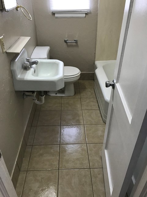 a bathroom with a sink and a toilet and a tub