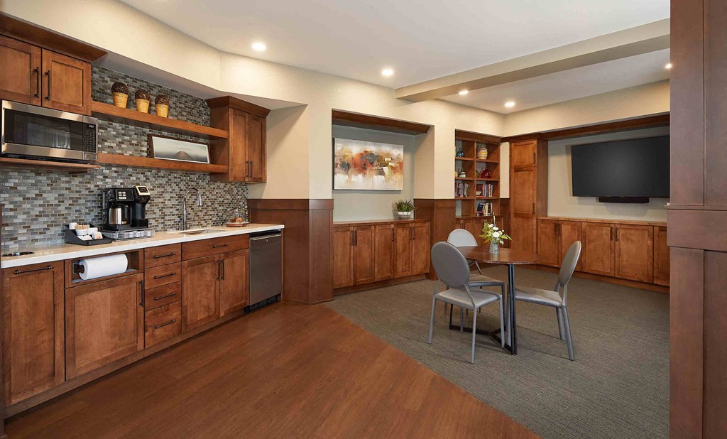 a kitchen and dining area in a hotel room