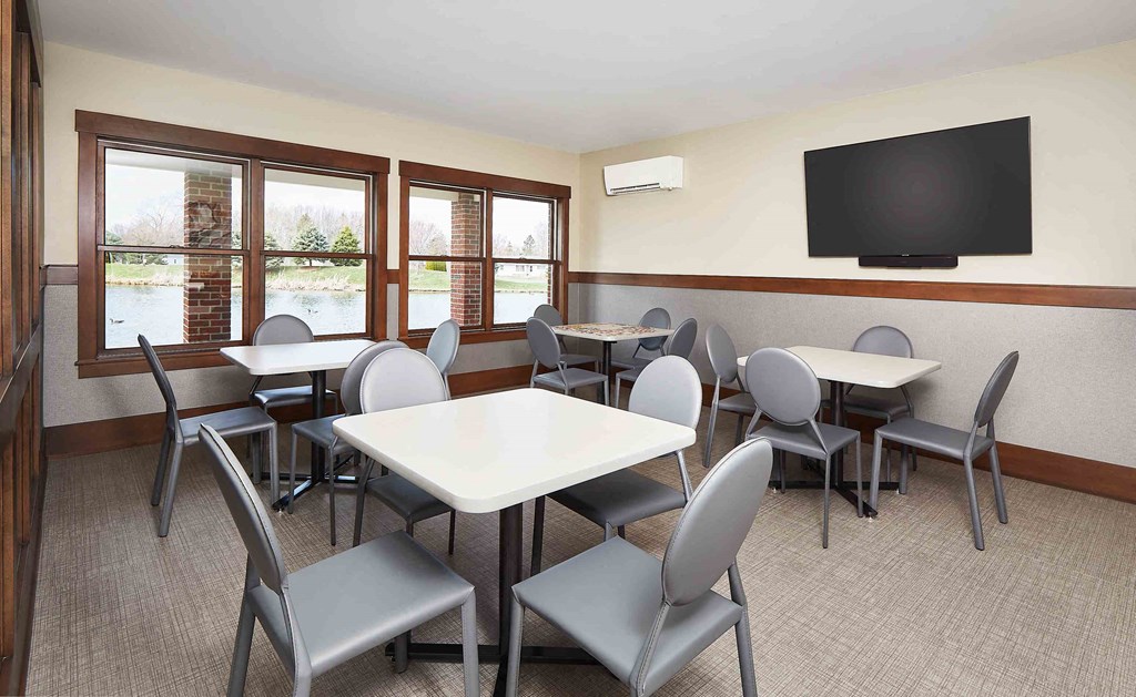 a dining room with tables and chairs and a television