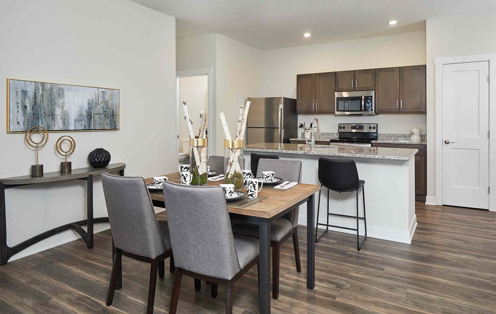 an open kitchen and dining room with a table and chairs