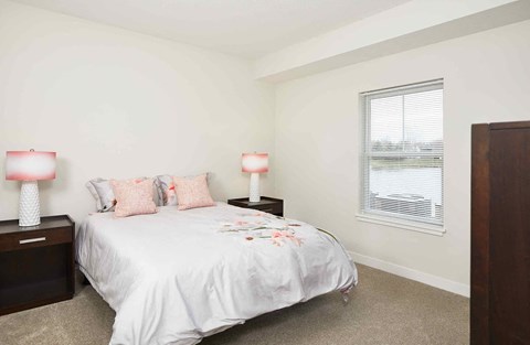 a bedroom with a bed and a window