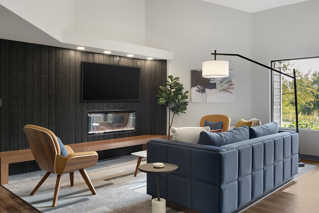 Lounge seating area with TV mounted over Fireplace