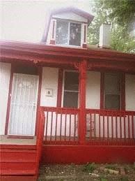 a red house with a porch and a window