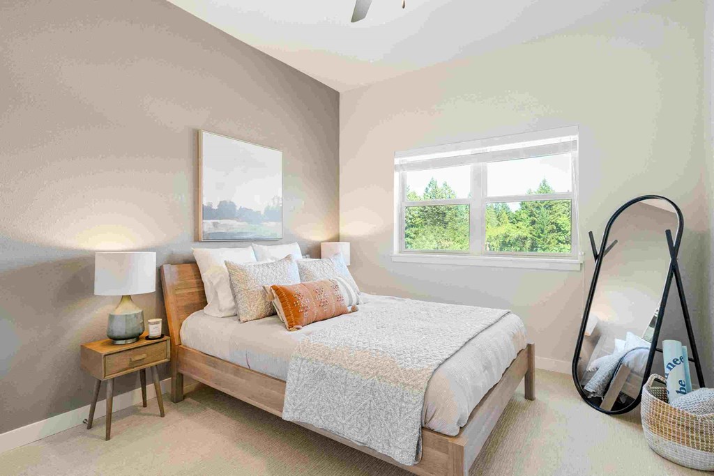 a bedroom with a bed and a mirror