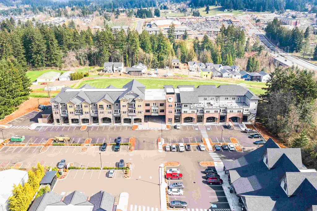 an aerial view of a hotel and parking lot