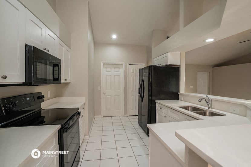 a kitchen with black appliances and white counter tops