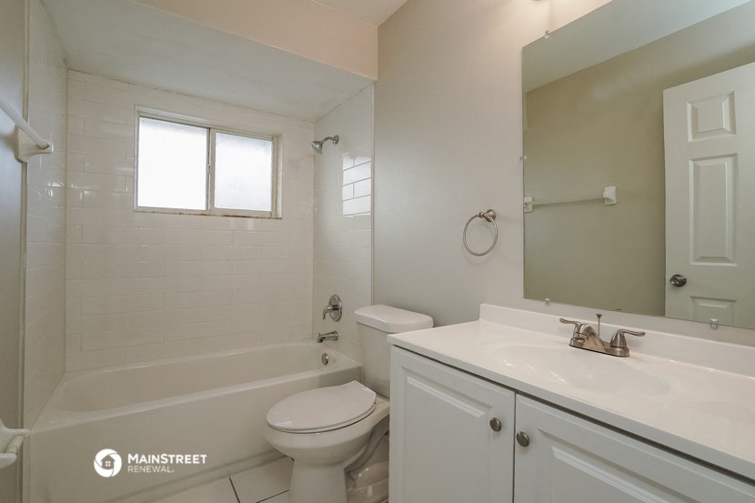 a bathroom with a sink toilet and a bath tub