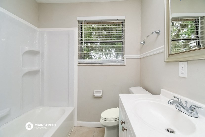 a bathroom with a sink and a toilet and a bath tub