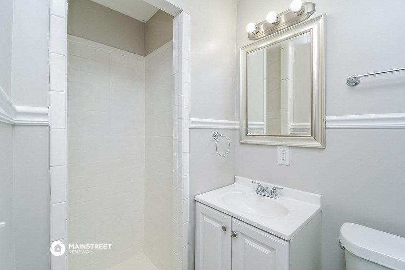 a bathroom with a sink and a mirror and a toilet