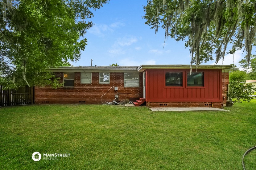 a red house with a bike parked in front of it