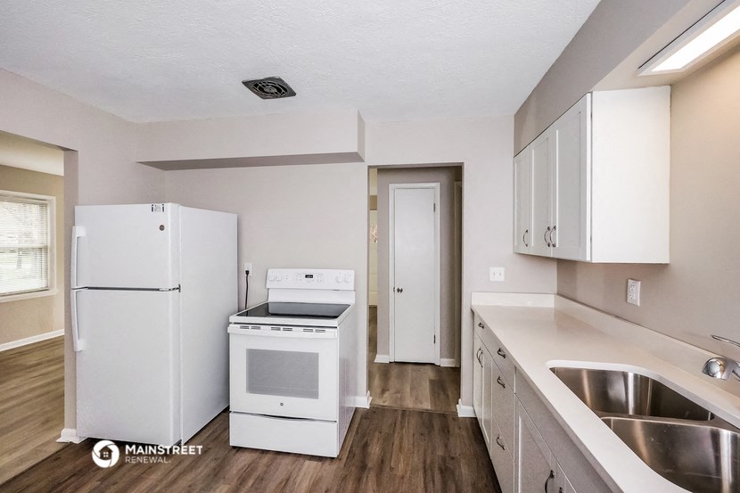 the preserve at ballantyne commons apartment kitchen with white appliances and white cabinets