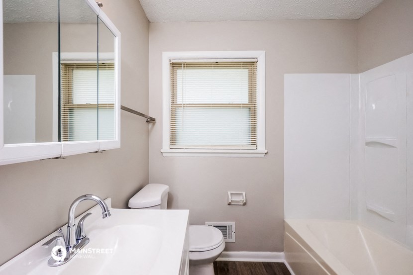 a bathroom with a sink toilet and a bath tub