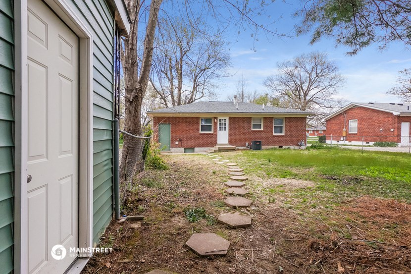 a small brick house with a pathway in front of it