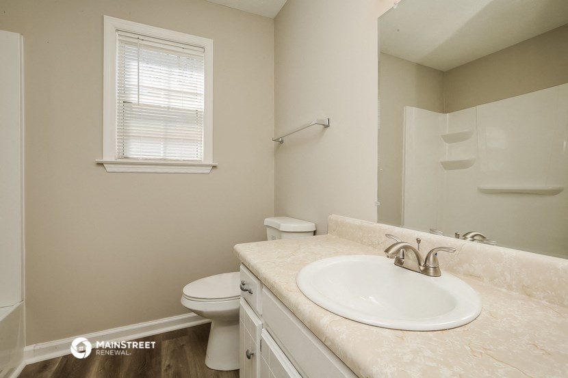 a bathroom with a sink and a toilet and a shower