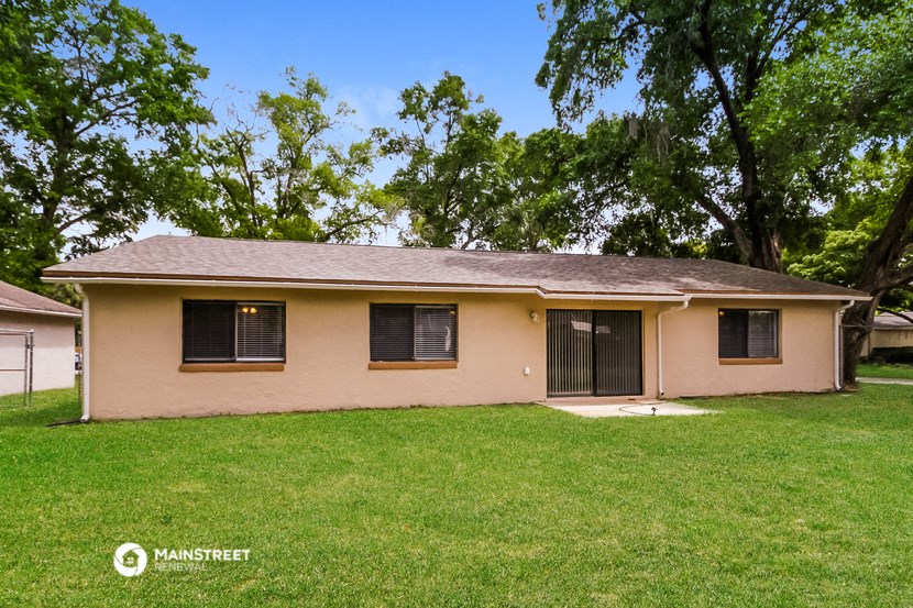 front view of a house with grass and trees