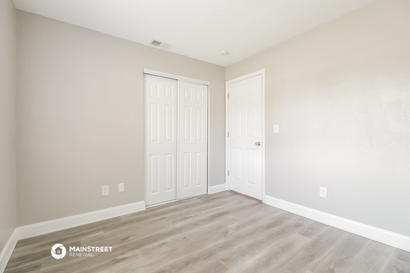 the living room of a new home with white walls and wood flooring