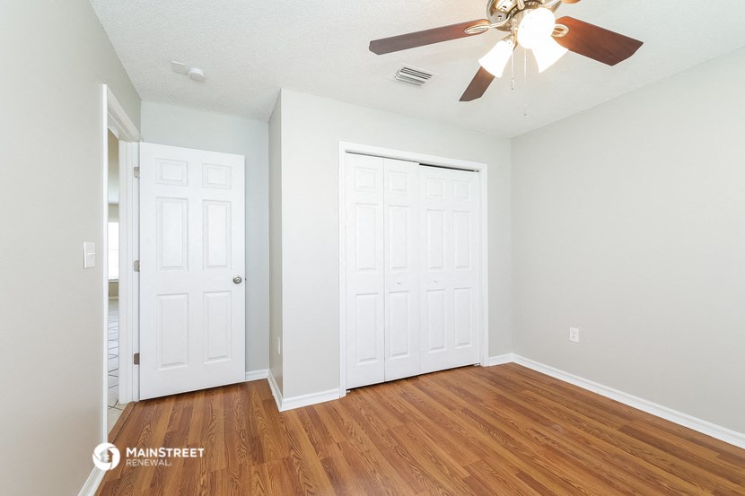 the living room of our two bedroom apartment atrium with a ceiling fan