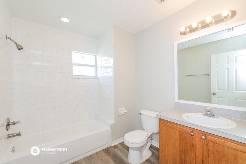 a bathroom with a shower toilet and sink and a mirror