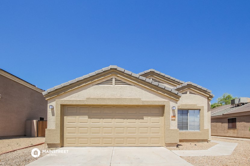 a tan brick house with a garage door