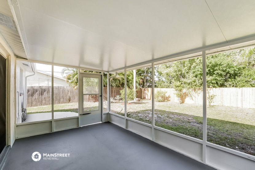 a living room with large windows and a patio